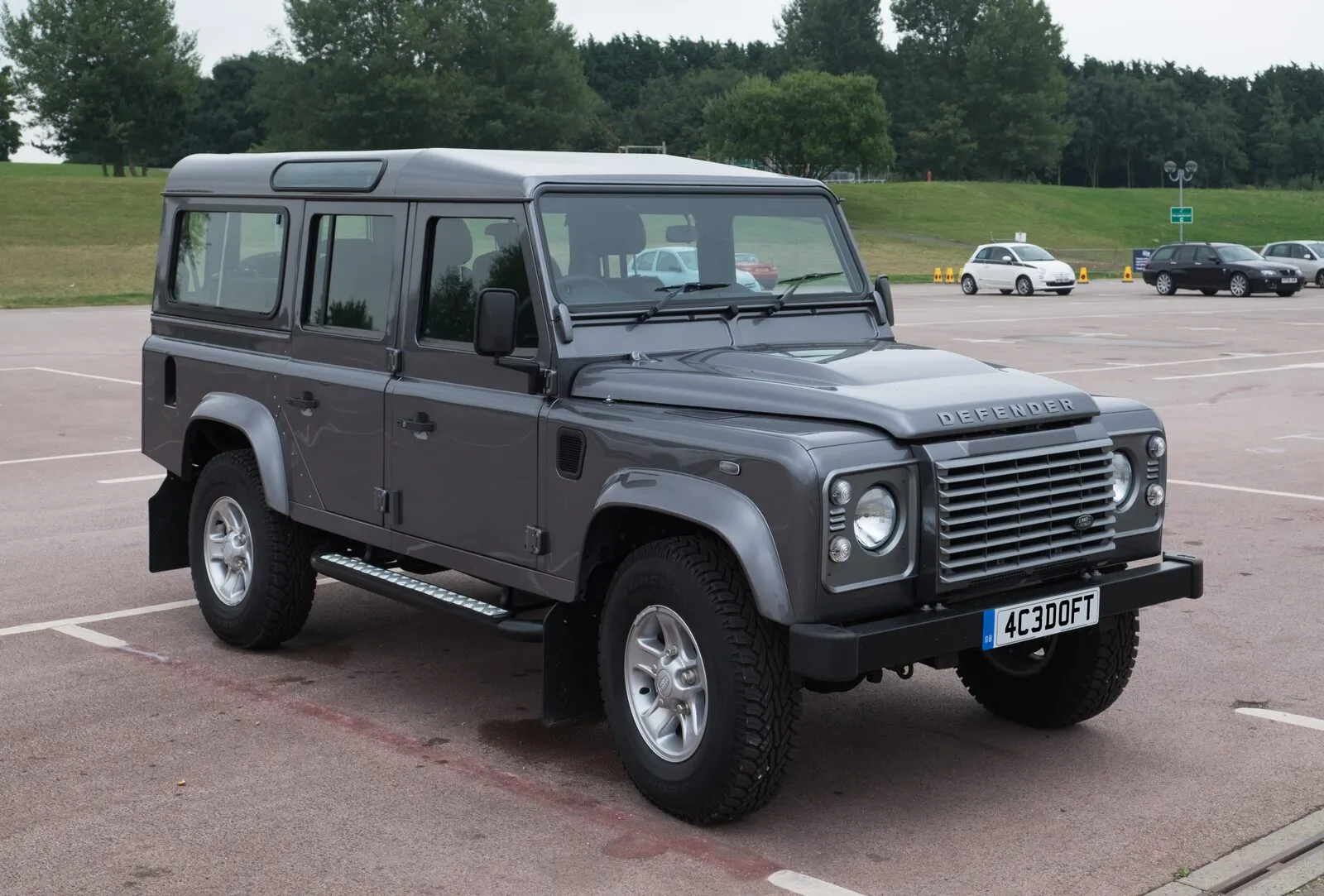Grey 2016 Land Rover Defender 110 Station Wagon, front three-quarter view on tarmac