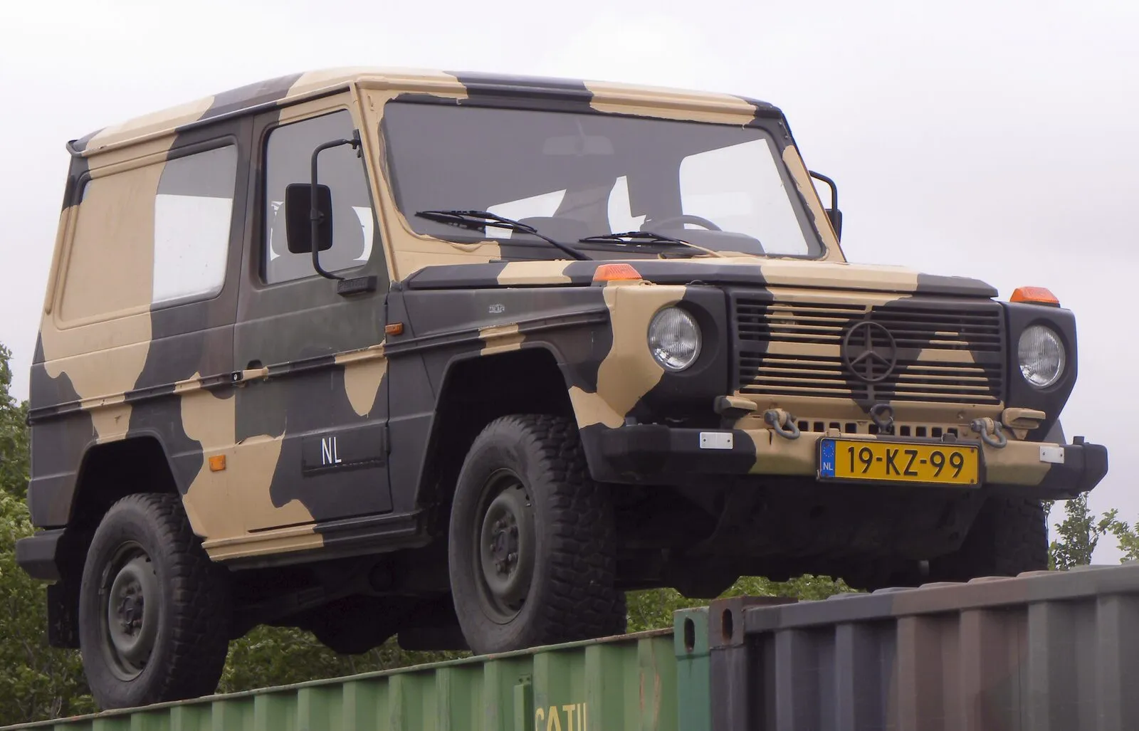 Mercedes-Benz 290 GD in Dutch army camouflage, side view on a container