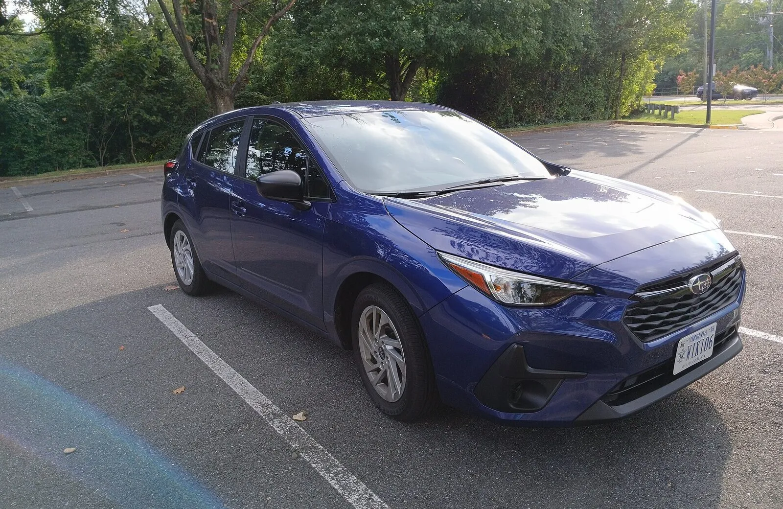 2024 Subaru Impreza hatchback in sapphire blue, front three-quarter view