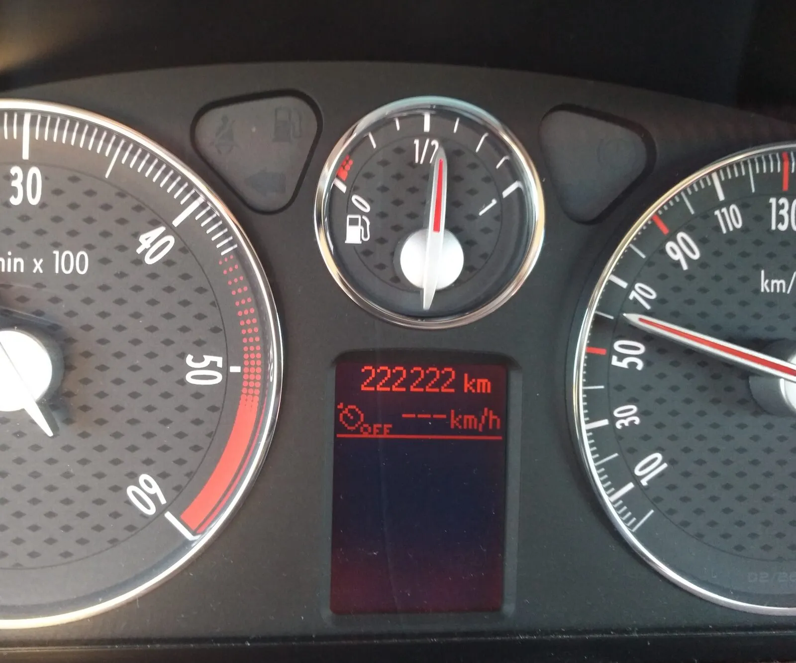 A car’s digital odometer and trip meter in the instrument cluster