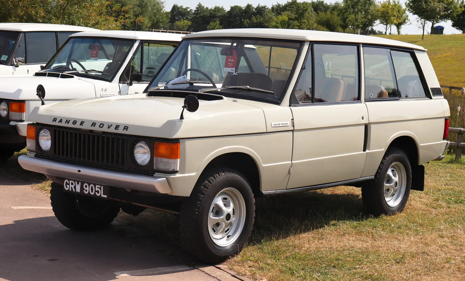 Cream-coloured 1973 two-door Range Rover Classic 3.5 on grass at a classic car show
