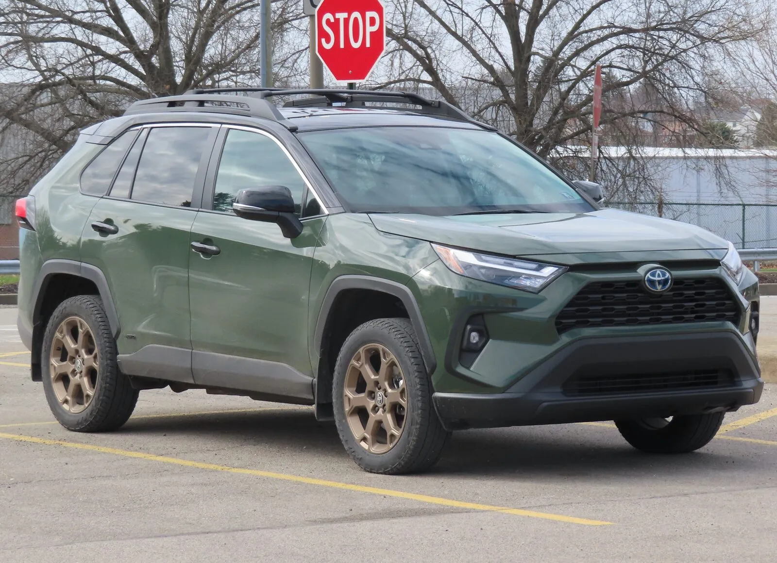 Army Green 2024 Toyota RAV4 Hybrid Woodland Edition, front three-quarter view, in a parking lot