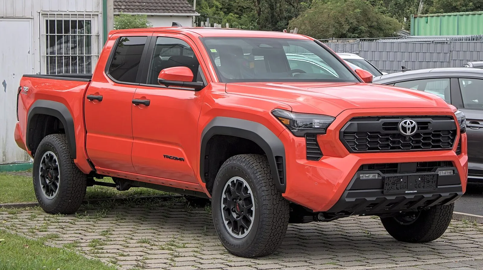 2024 Toyota Tacoma TRD Off-Road pickup in red, front three-quarter view