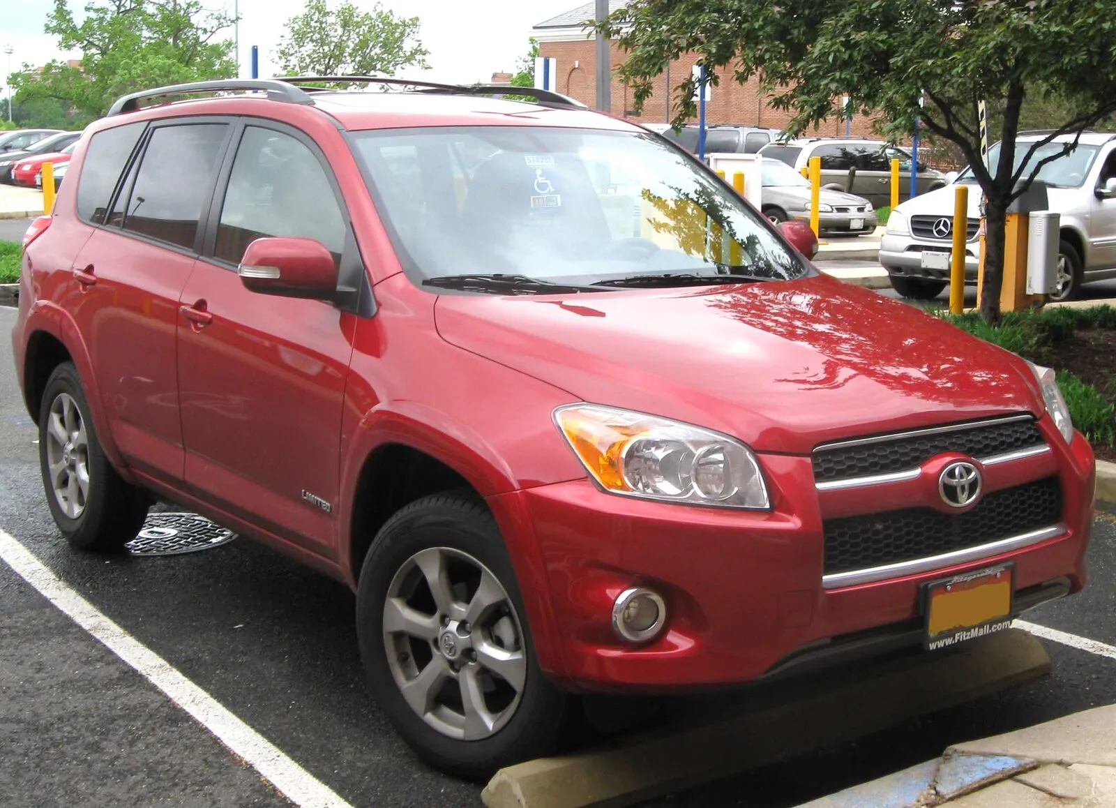 Red 2009 Toyota RAV4 Limited, front three-quarter view, parked at a curb