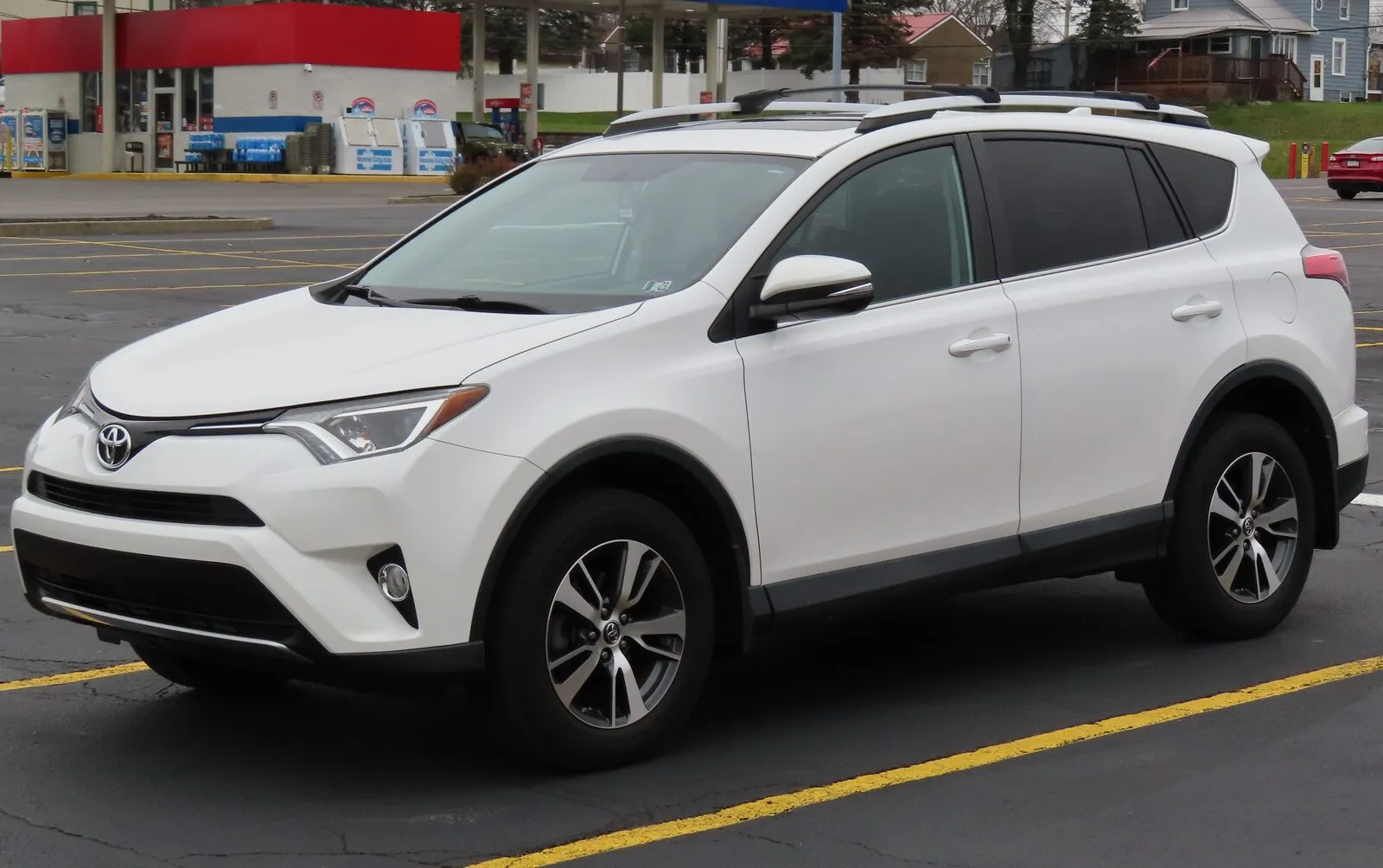White 2016 Toyota RAV4 XLE AWD, front three-quarter view, in a parking lot